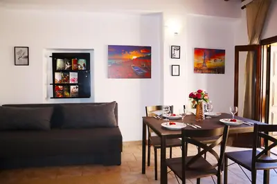 a living room with a table and a couch at Calma Apartment Chania in Chania Town