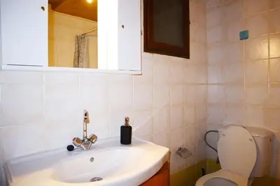 a bathroom with a sink and a toilet at Calma Apartment Chania in Chania Town
