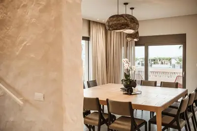 a dining room with a wooden table and chairs at Villa Agali I 