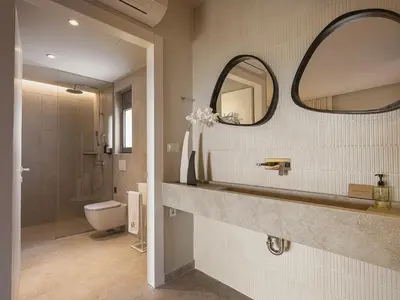 a bathroom with a sink and a toilet and a mirror at Villa Agali I 
