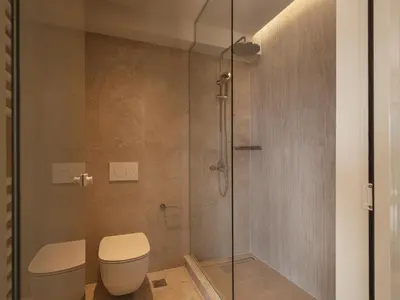 a bathroom with a toilet and a glass shower at Villa Agali I 