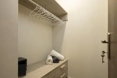 a room with a closet with a shelf and a door at Chris villa with private ecologic pool and kid's playground! in Chania Town