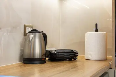 a coffee maker on a counter next to a roll of paper towels at Chris villa with private ecologic pool and kid's playground! in Chania Town
