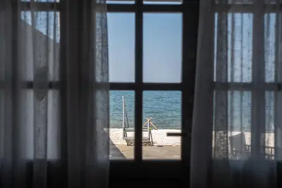 a view of the ocean from a window at Seasound apartments in Galatás