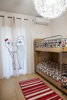 a bedroom with a bunk bed and a chandelier at Villa Pandora - Angela & Michali in Maleme