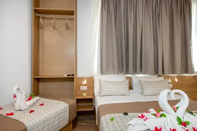 two beds in a room with swans on them at DELUXE MAISONETTE in Chania Town
