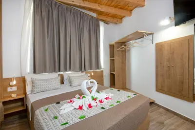 a bedroom with a bed with towels on it at DELUXE MAISONETTE in Chania Town