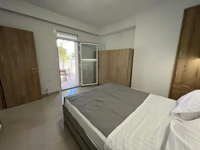 a bedroom with a large bed and a large window at Veryhome in Maleme
