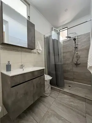 a bathroom with a sink and a shower at Veryhome in Maleme