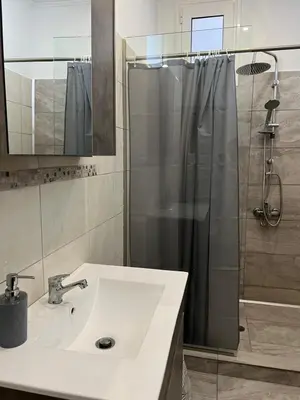 a bathroom with a sink and a shower at Veryhome in Maleme