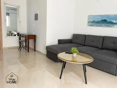 a living room with a couch and a table at Veryhome in Maleme