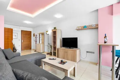 a living room with a couch and a tv at Emmanouel Maisonette near the Sea in Parigoría