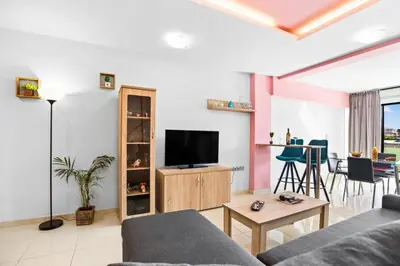 a living room with a couch and a tv at Emmanouel Maisonette near the Sea in Parigoría