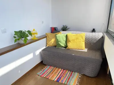 a couch with yellow and green pillows in a room at Icarus Loft Old Town rooftop terrace in Chania Town
