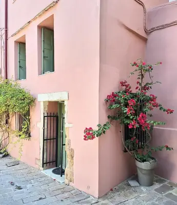 a pink building with a potted plant on it at Icarus Loft Old Town rooftop terrace in Chania Town