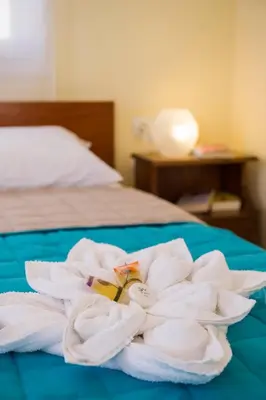 a pile of towels sitting on top of a bed at Penelopi Rooms in Chania Town