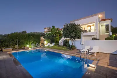 a swimming pool in front of a house at Villa Katerina with Private Pool in Chania Town
