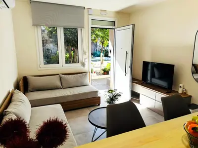 a living room with a couch and a television at Matina Room in Chania Town