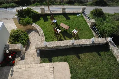 an overhead view of a garden with two chairs and a bench at Villa Nimertis in Xirokámbion