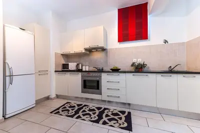 a kitchen with white cabinets and a refrigerator at Seascape in Tersanas