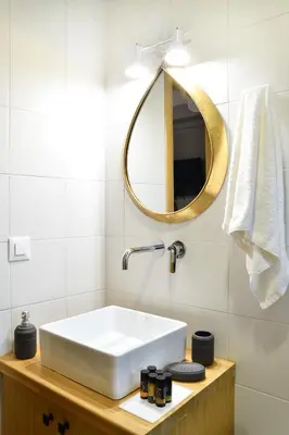 a bathroom with a white sink and a mirror at Alexandras's Mansion in Ayiá