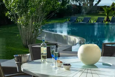 a table with a bottle of wine and a glass at Villa Elvina in Kissamos