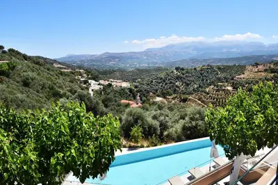 a villa with a swimming pool and a mountain view at Alexandras's Mansion - Alexinia's House in Ayiá