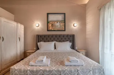 a bedroom with a bed with two towels on it at Alexandras's Mansion - Alexinia's House in Ayiá