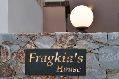 a sign on a stone wall with a light at Alexandras's Mansion - Fragkia's House in Ayiá