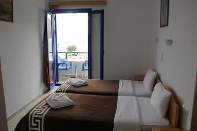 a bedroom with a bed with towels on it at Hotel Stavris in Khóra Sfakíon