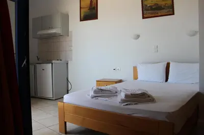 a bedroom with a bed with two towels on it at Hotel Stavris in Khóra Sfakíon