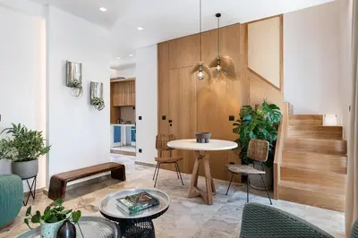 a living room with a table and chairs at Domi Luxury Apartment by Cura Villas Collection in Chania Town