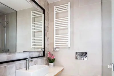 a bathroom with a sink and a mirror at Villa Aglaea I Saltwater Pool & Amazing Seaview! in Chania Town