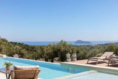 a villa with a swimming pool with a view of the ocean at Villa Aglaea I Saltwater Pool & Amazing Seaview! in Chania Town