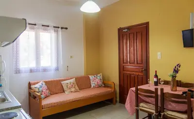 a living room with a couch and a table at Anchris Paleochora in Palaiochóra