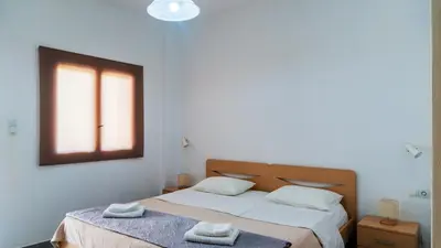 a bedroom with two beds with towels on them at Anchris Paleochora in Palaiochóra