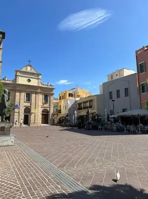 a town square with a bird standing in the street at Carlas House, Kalyves in Tsivarás