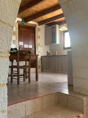 a kitchen with a table and a dining room at Carlas House, Kalyves in Tsivarás