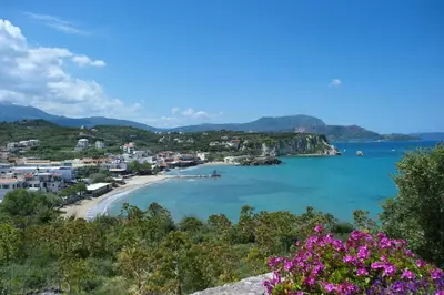 a view of a beach with pink flowers at Villa Athena by Villa Plus in Almirida