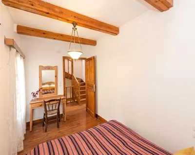 a bedroom with a bed and a table and a mirror at Yiayia's Place in Chania in Chania Town