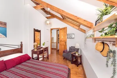 a bedroom with a bed and a desk in a room at Yiayia's Place in Chania in Chania Town