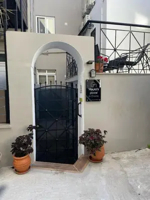a door to a house with two potted plants at Yiayia's Place in Chania in Chania Town