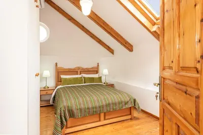 a bedroom with a bed and a wooden door at Yiayia's Place in Chania in Chania Town