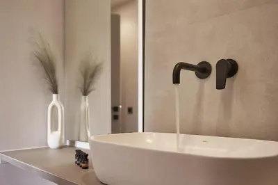 a sink in a bathroom with a faucet at Thearia villa I - seaview , private heated pool & jacuzzi in Souda