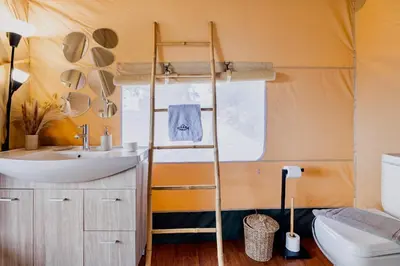 a bathroom with a toilet and a sink and a ladder at Civara Chalet - Private Glamping in nature with Jacuzzi in Tsivarás