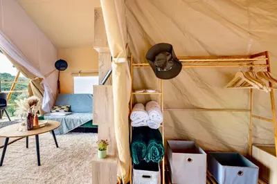 a room with a tent with a bed and a table at Civara Chalet - Private Glamping in nature with Jacuzzi in Tsivarás