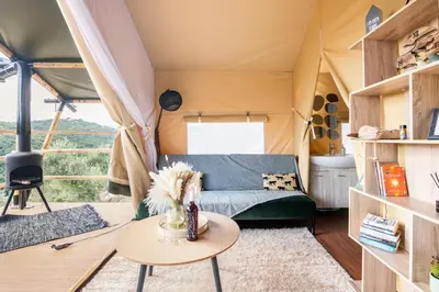 a living room with a couch in a tent at Civara Chalet - Private Glamping in nature with Jacuzzi in Tsivarás