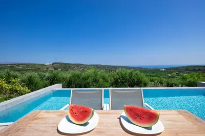 a table with two slices of watermelon sitting on it at Villa Idyllic in Maleme