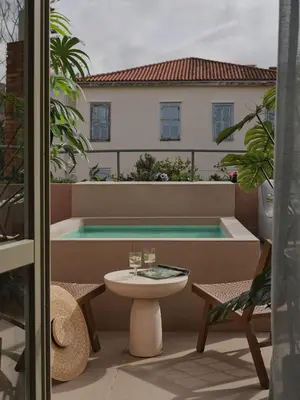 a balcony with a table and a swimming pool at Domus Blanc Boutique Hotel in Chania Town