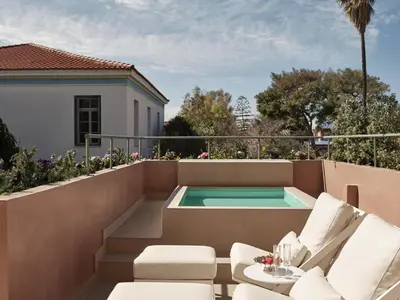 a patio with a hot tub on the roof of a house at Domus Blanc Boutique Hotel in Chania Town